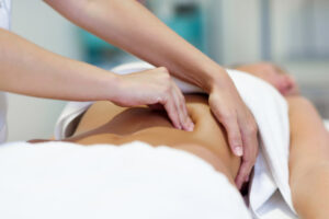 woman-having-abdomen-massage-by-professional-osteopathy-therapist